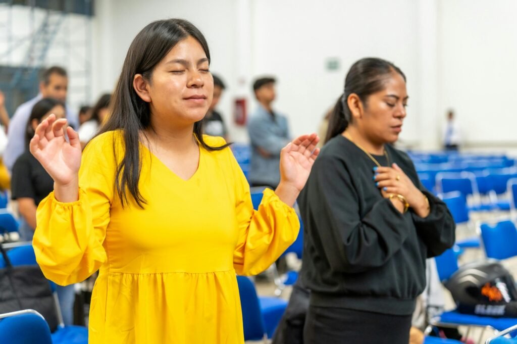 Two women in prayer during a religious ceremony in a church in Ciudad de México.